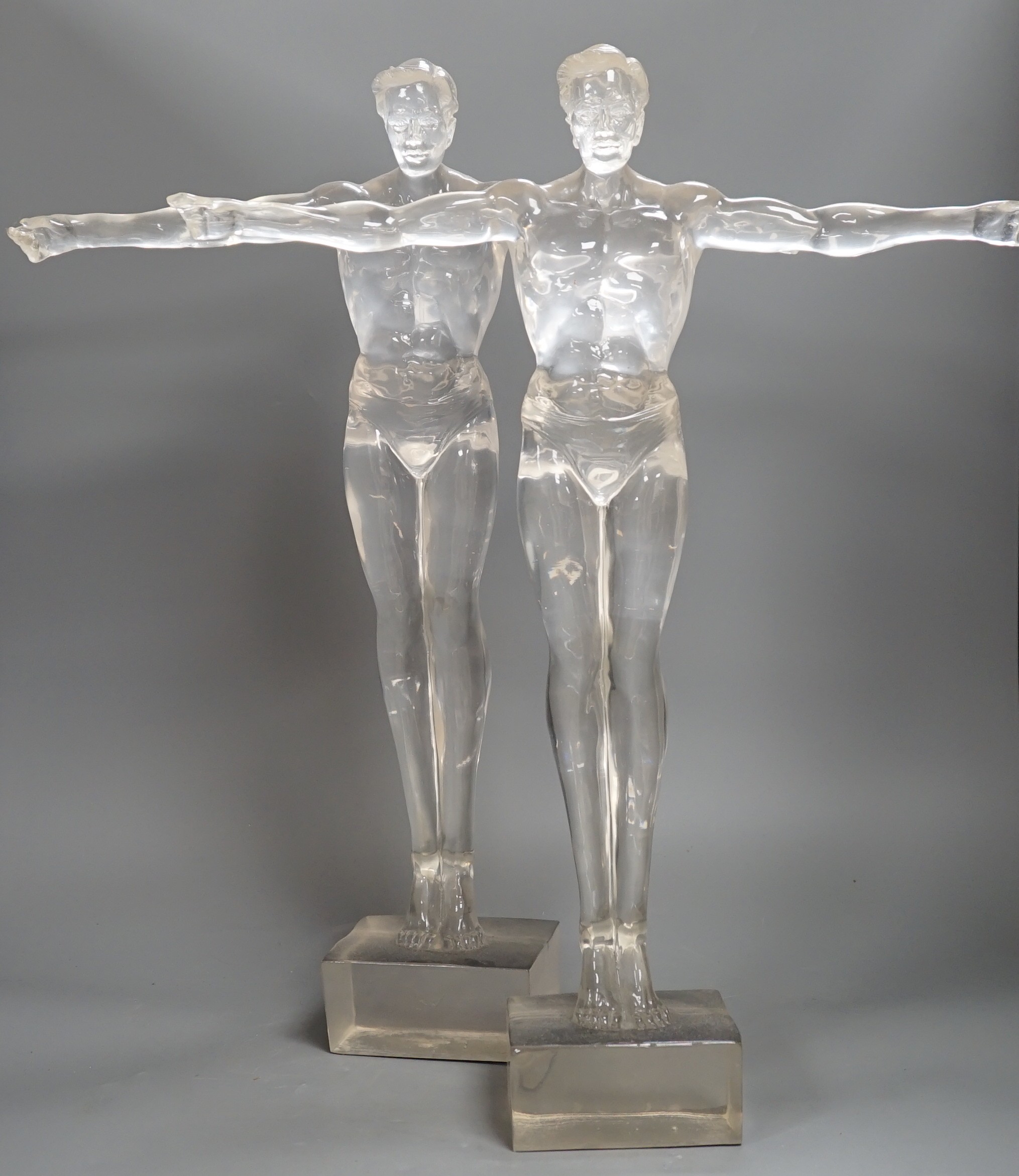 A pair of clear perspex models of male swimmers, 57cms high